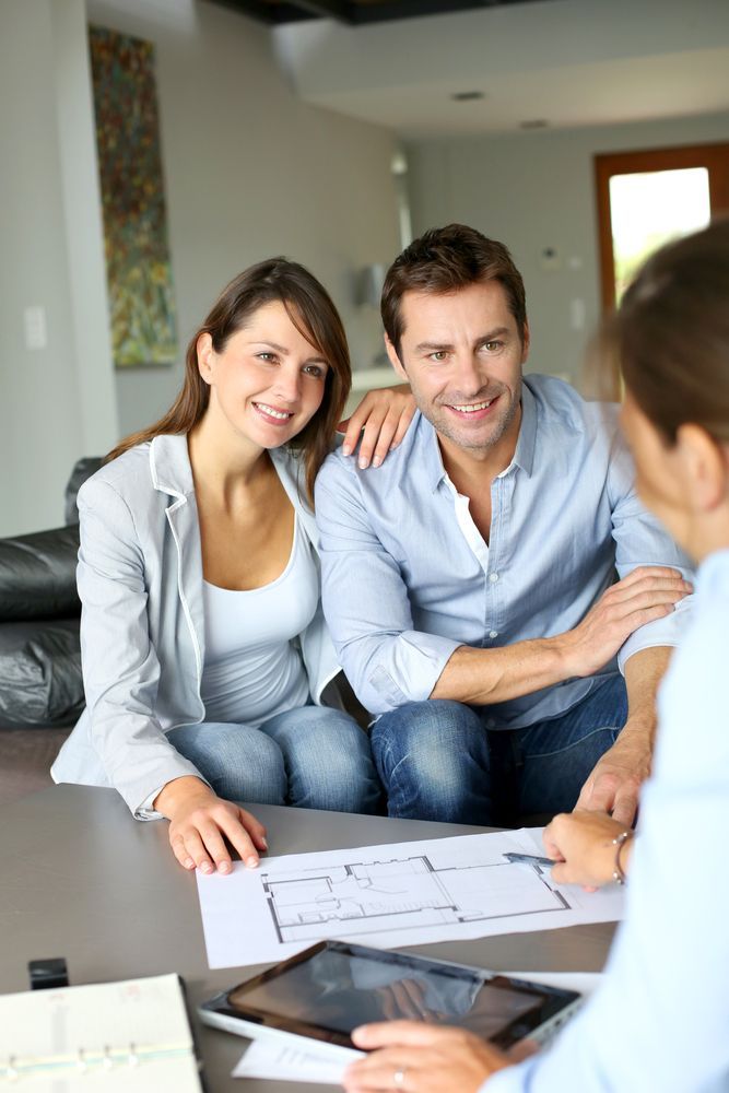 Couple Reviewing Blueprints with A Professional — Freedom Wealth Solutions in Mornington, VIC