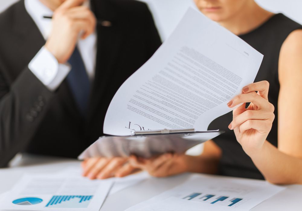 Two People Reviewing Documents at A Table — Freedom Wealth Solutions in Mornington, VIC