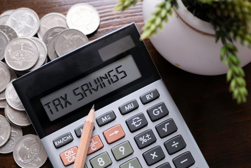 Calculator Displaying with Coins, and A Pencil — Freedom Wealth Solutions in Mornington, VIC