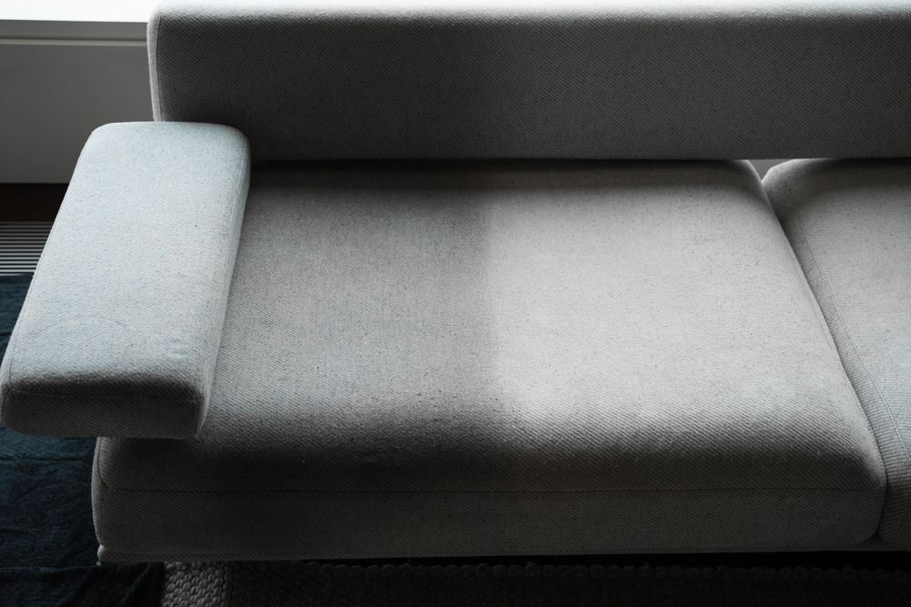 A close up of a gray couch in a living room.