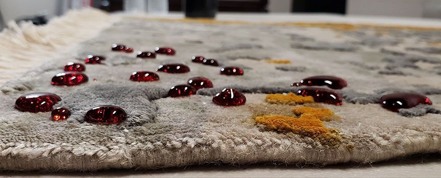 Close-up of a flatbread topped with red berries and orange seasoning on a countertop