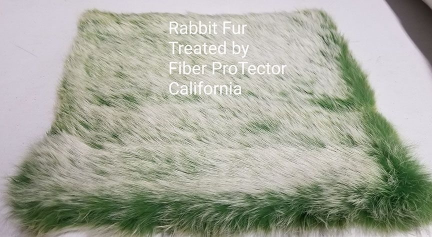 White and green rabbit fur sample with text reading “Rabbit Fur Treated by Fiber Protector California”