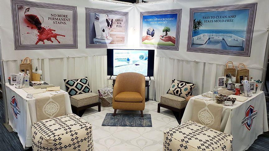 Cozy lounge with tan chair, patterned stools, framed art, and a TV centered against a white backdrop.