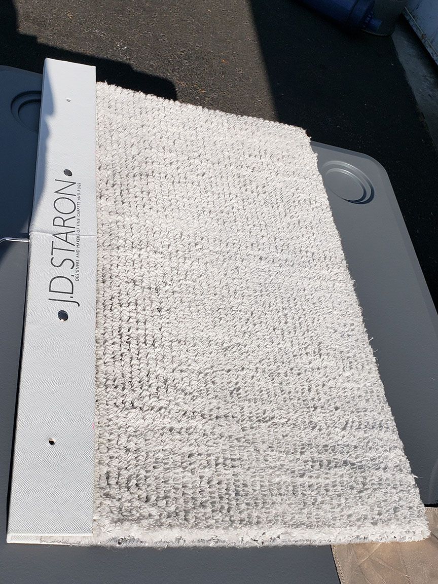 White textured panel with handwritten label beside a gray device surface.