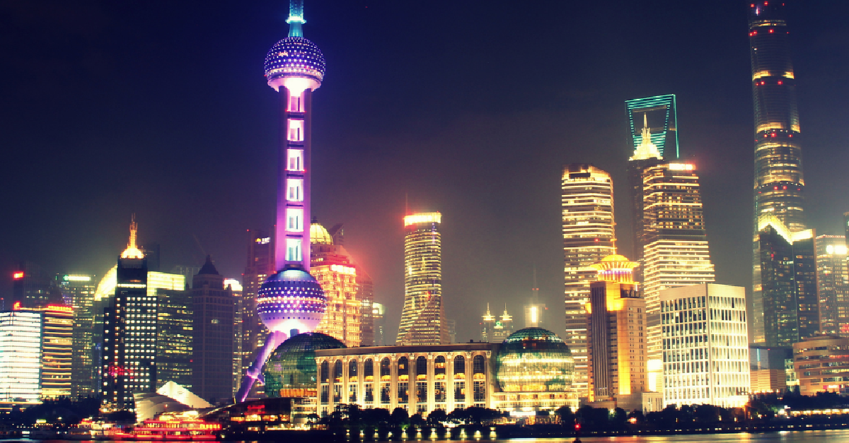 A city skyline at night with a tower in the middle