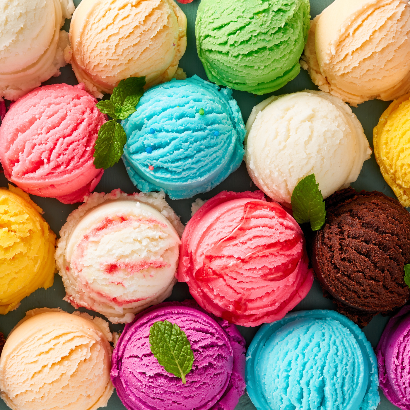 I cream scoops lined in rows, several different flavors and colors. 