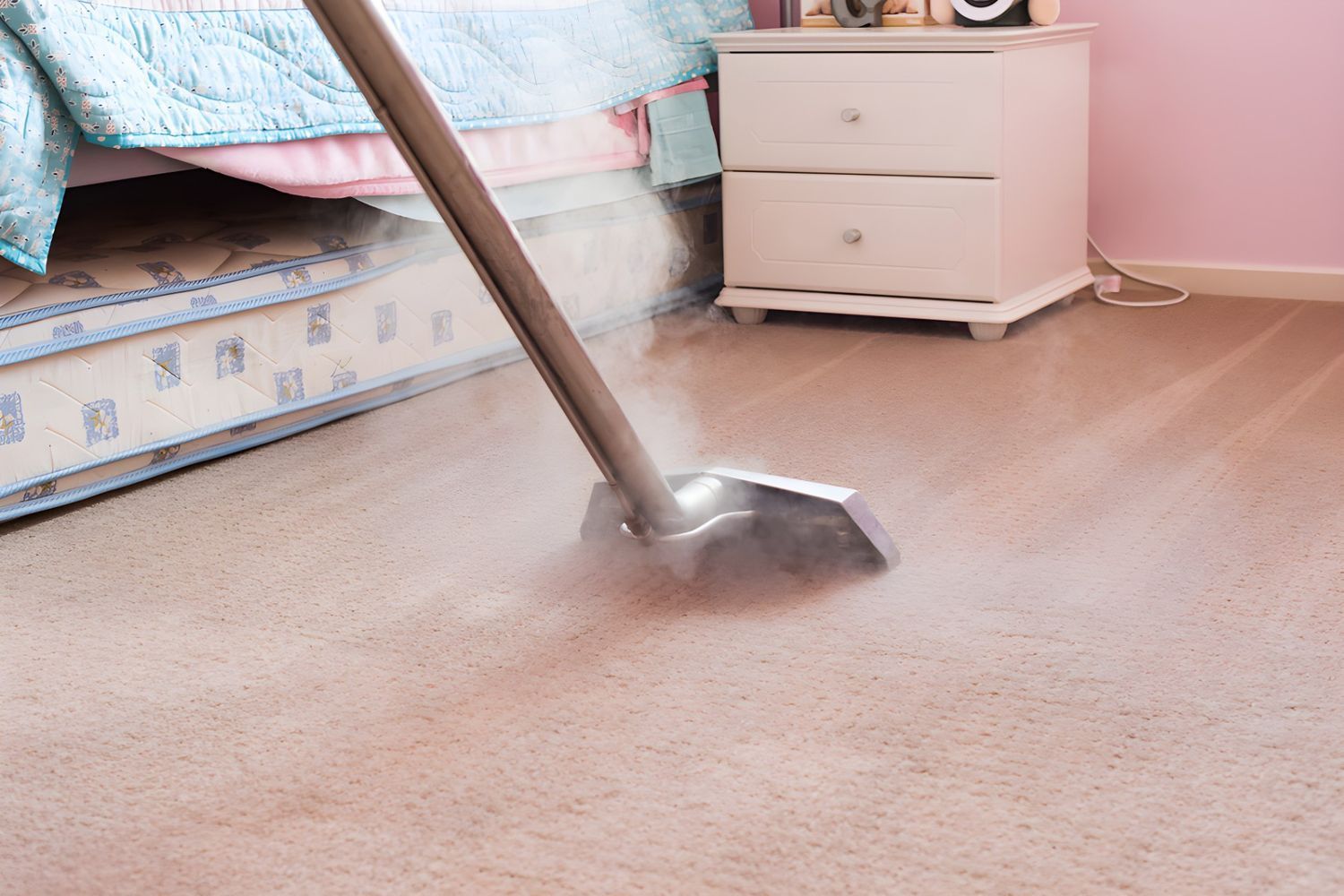 A Person is Using a Vacuum Cleaner to Clean a Carpet in a Bedroom — Great Lakes Carpet Cleaning & Restoration In Pacific Palms, NSW