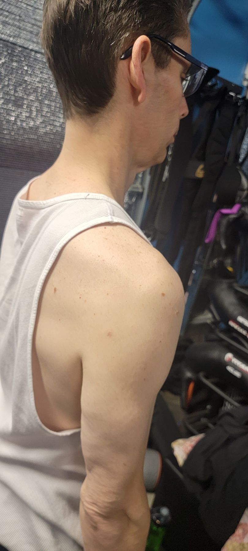 Man showing shoulder and upper back posture in profile