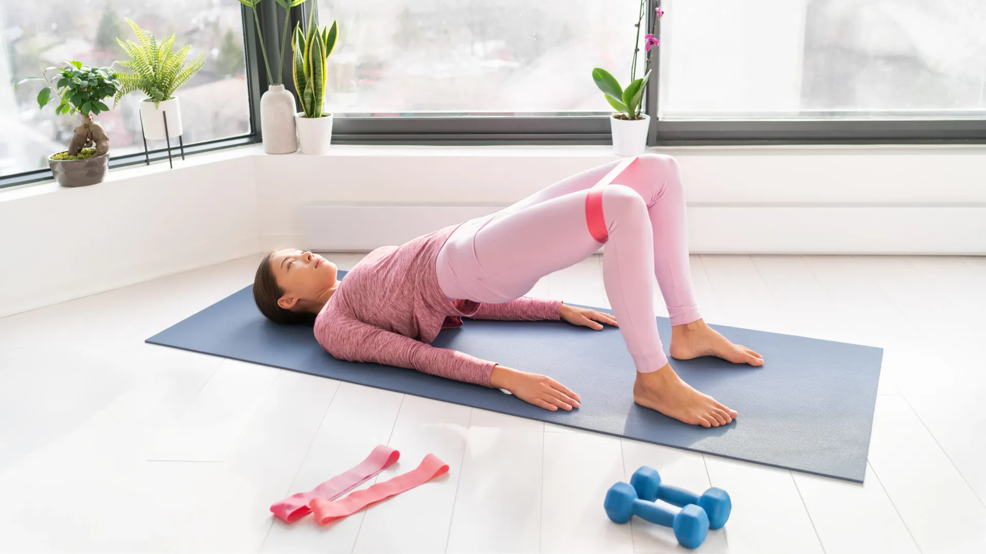 Woman performing a glute bridge for pelvic floor strength training