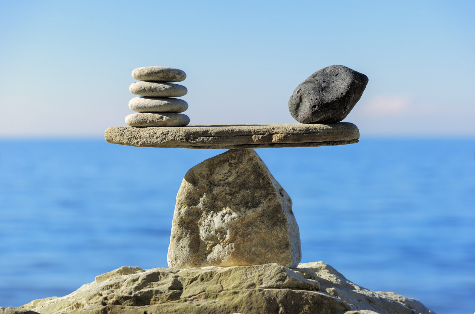 A balanced stone structure on the seashore, symbolizing equilibrium in the body.