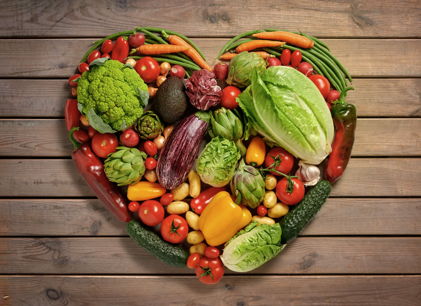 Heart shape made of fresh vegetables symbolising healthy nutrition and heart health