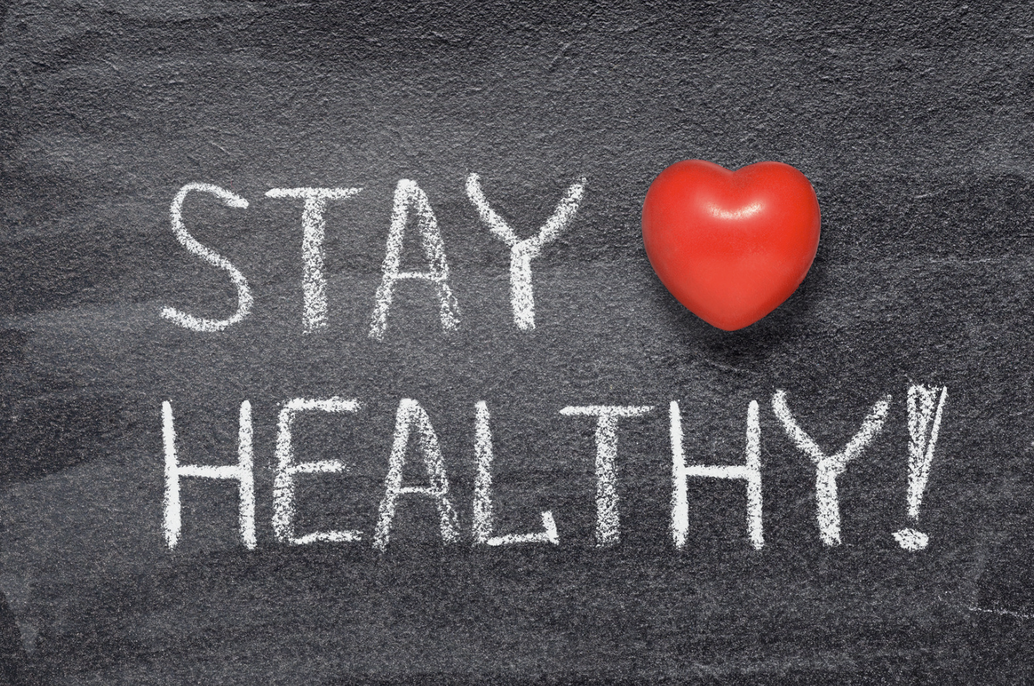 Stay healthy message with red heart symbol on chalkboard background