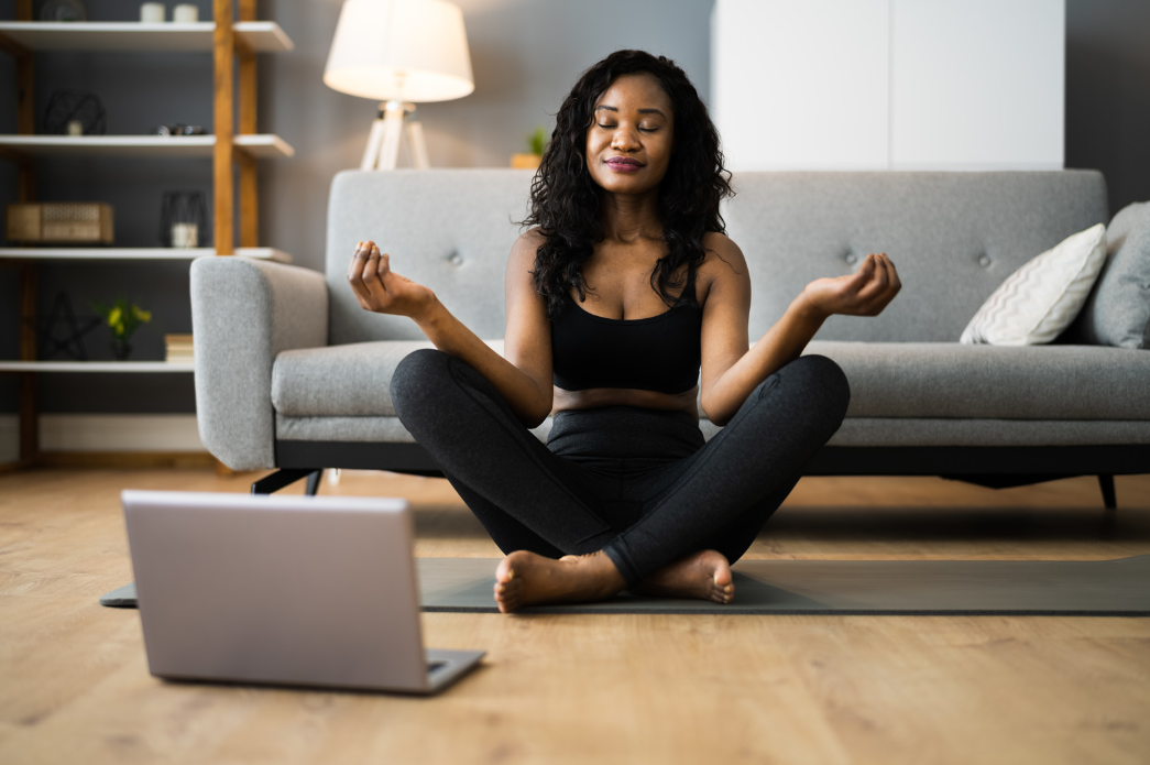Woman meditating at home for stress management and healthy habits