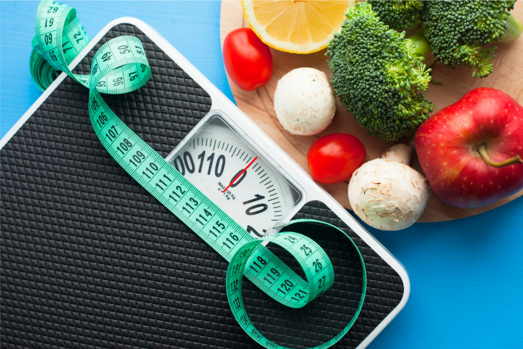 Healthy foods and scale symbolizing sustainable weight loss strategies