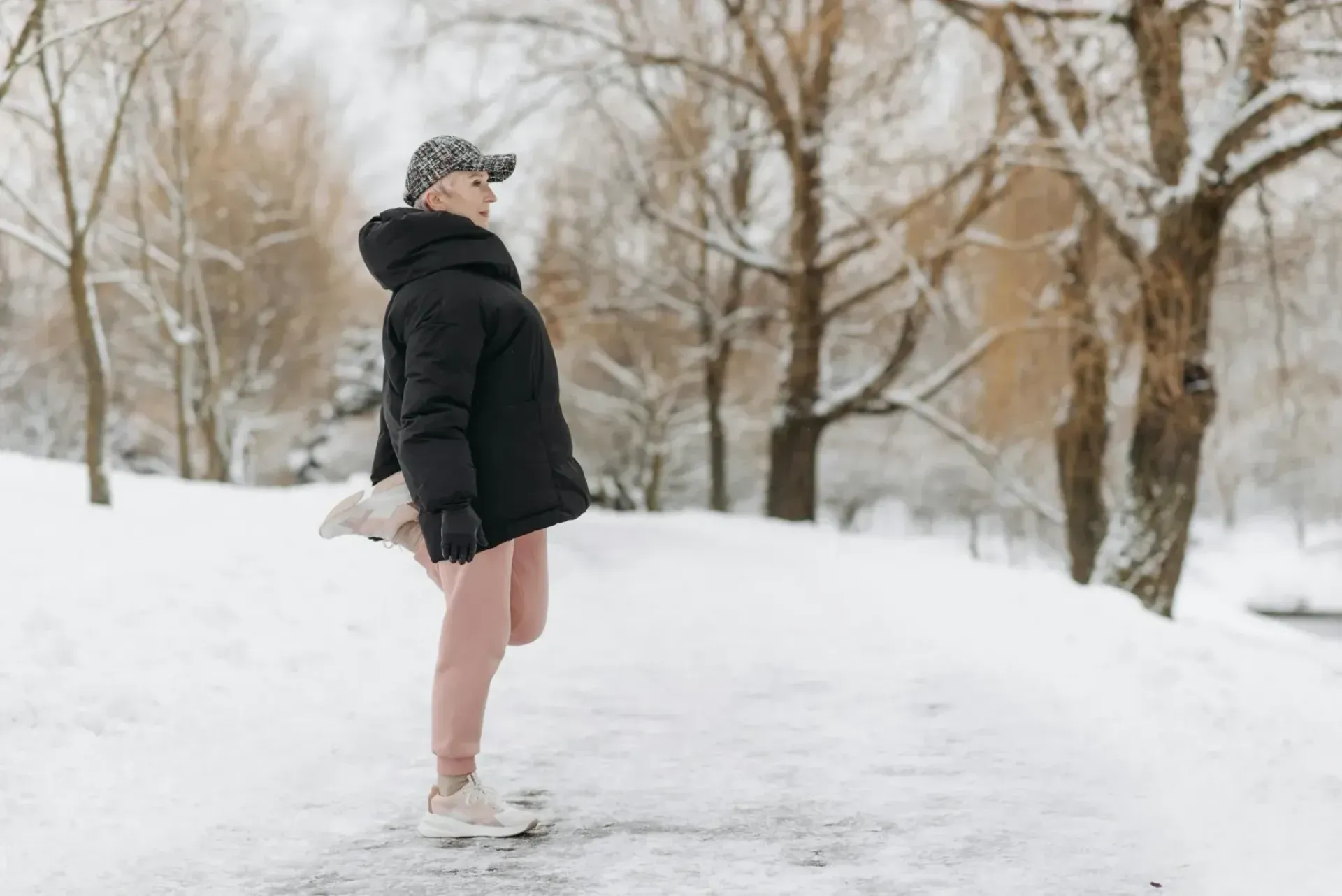Person stretching in snow for winter holiday strength training