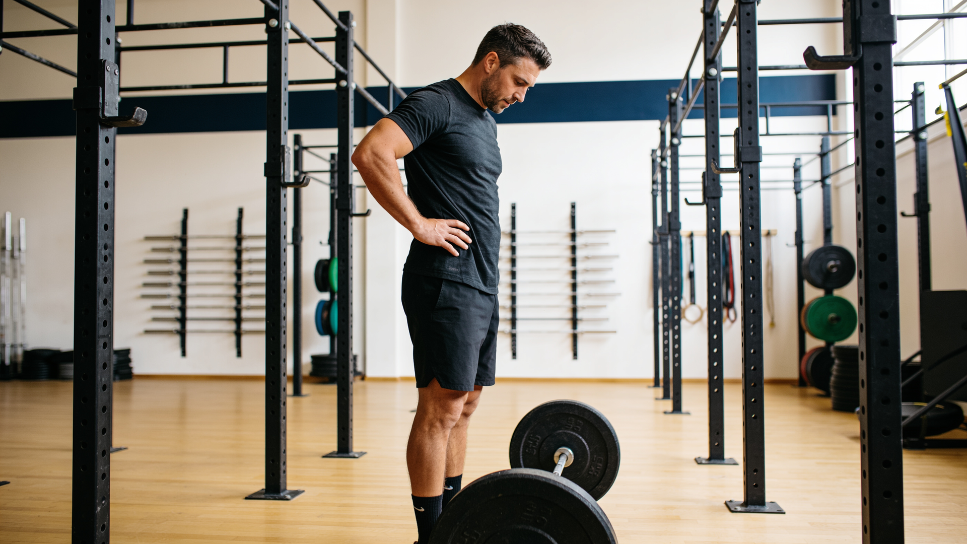 Lifter pausing mid-set to decide whether to add weight or keep the rep clean.