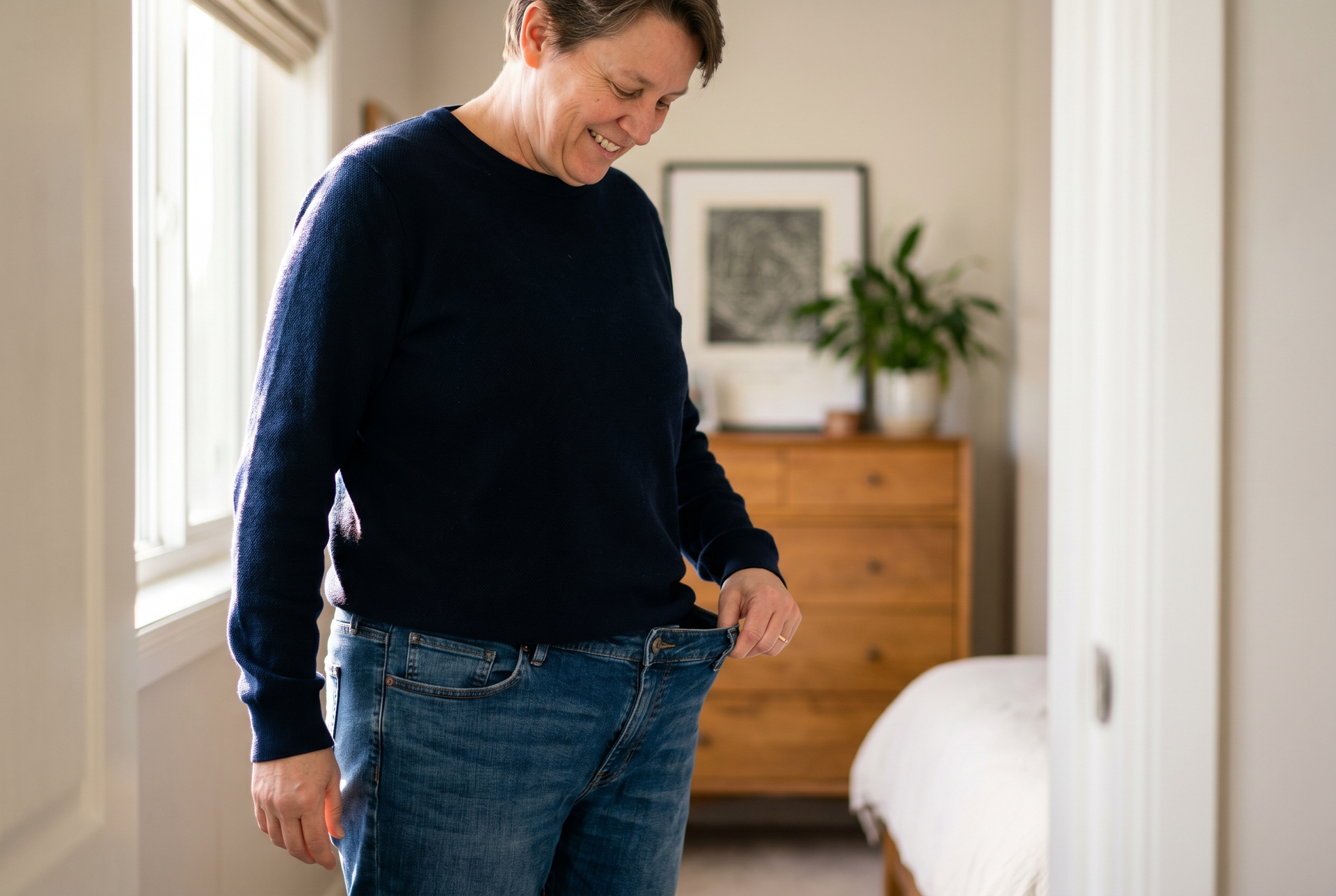 Adult noticing their clothes fit more loosely, a body-composition change the scale cannot show.