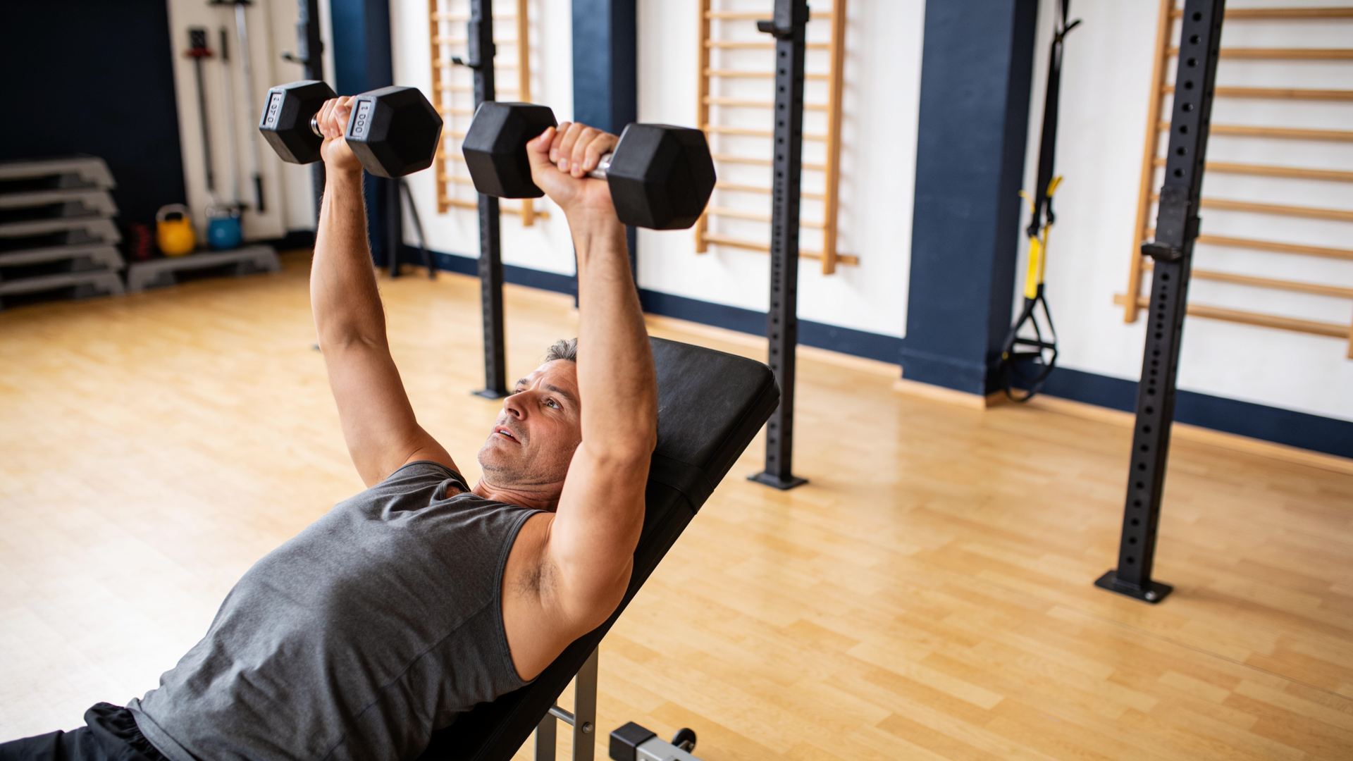 Adult in their forties performing a controlled compound strength lift, strong and capable.