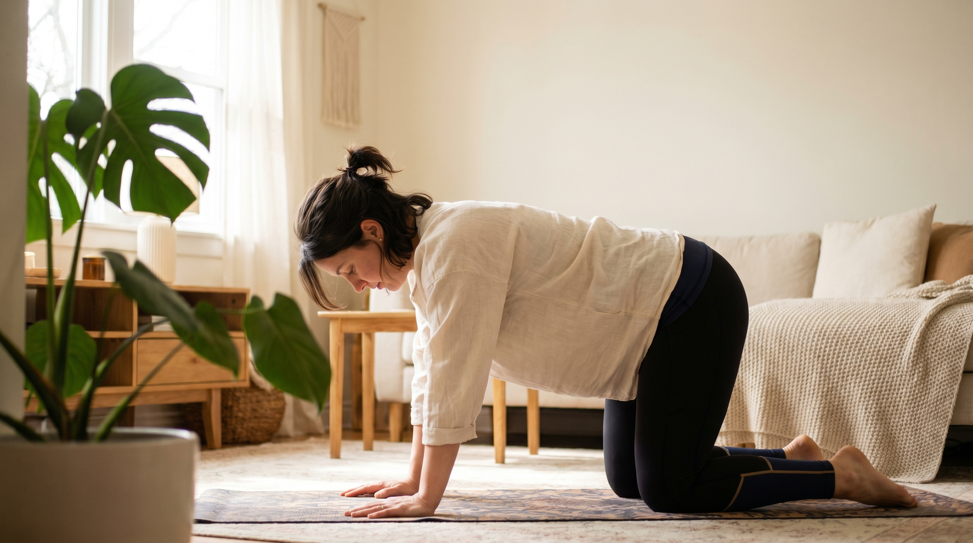 Pregnant woman in a gentle prenatal yoga position on a mat, calm and comfortable.