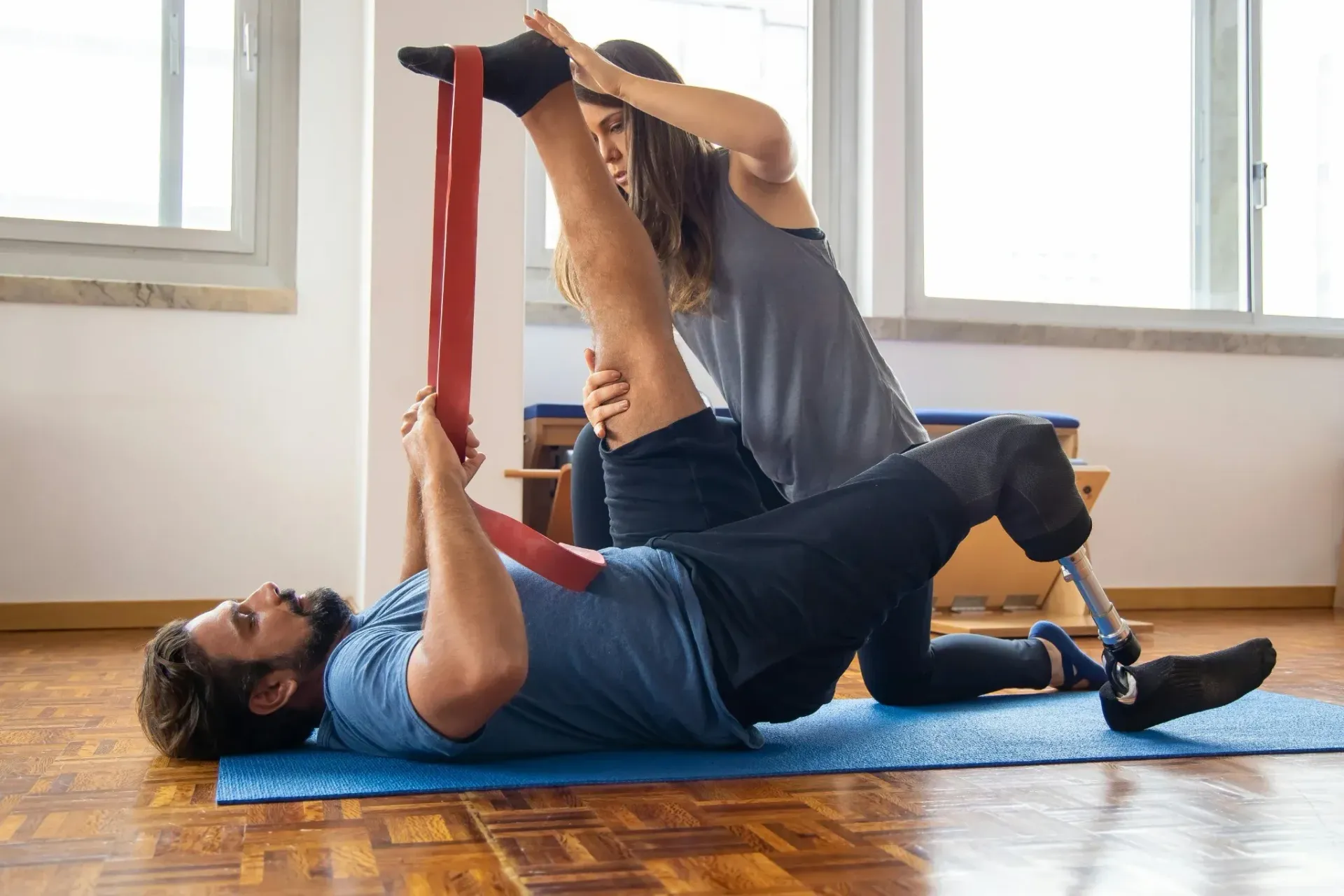 Person performing guided strength and mobility exercise after physical therapy to bridge the gap to full training