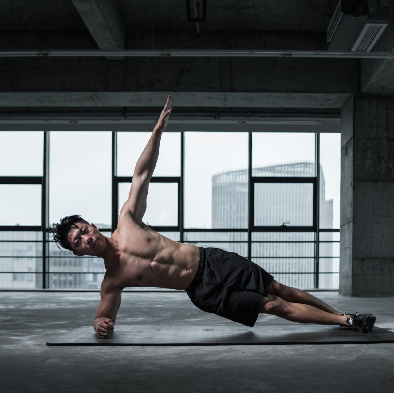 Person performing side plank exercise for oblique strength and core stability