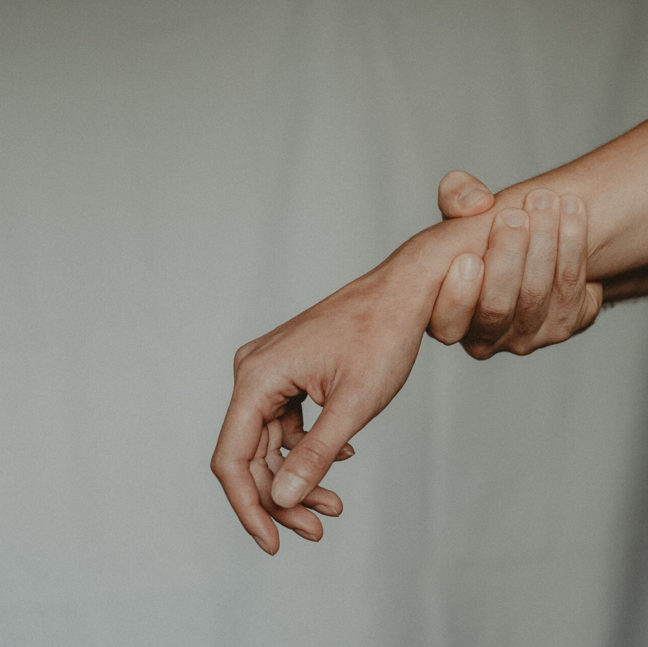 Close-up of person holding wrist for forearm and grip discomfort