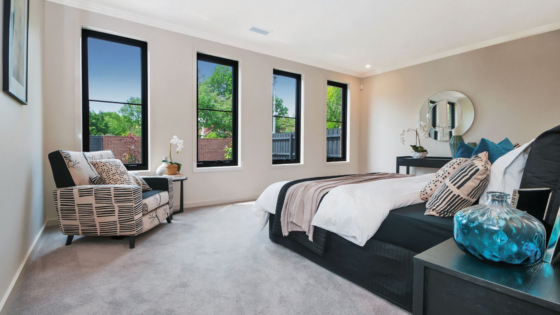 Bedroom With Large Windows, and Patterned Chair — K & J Glass in Warrell Creek, NSW