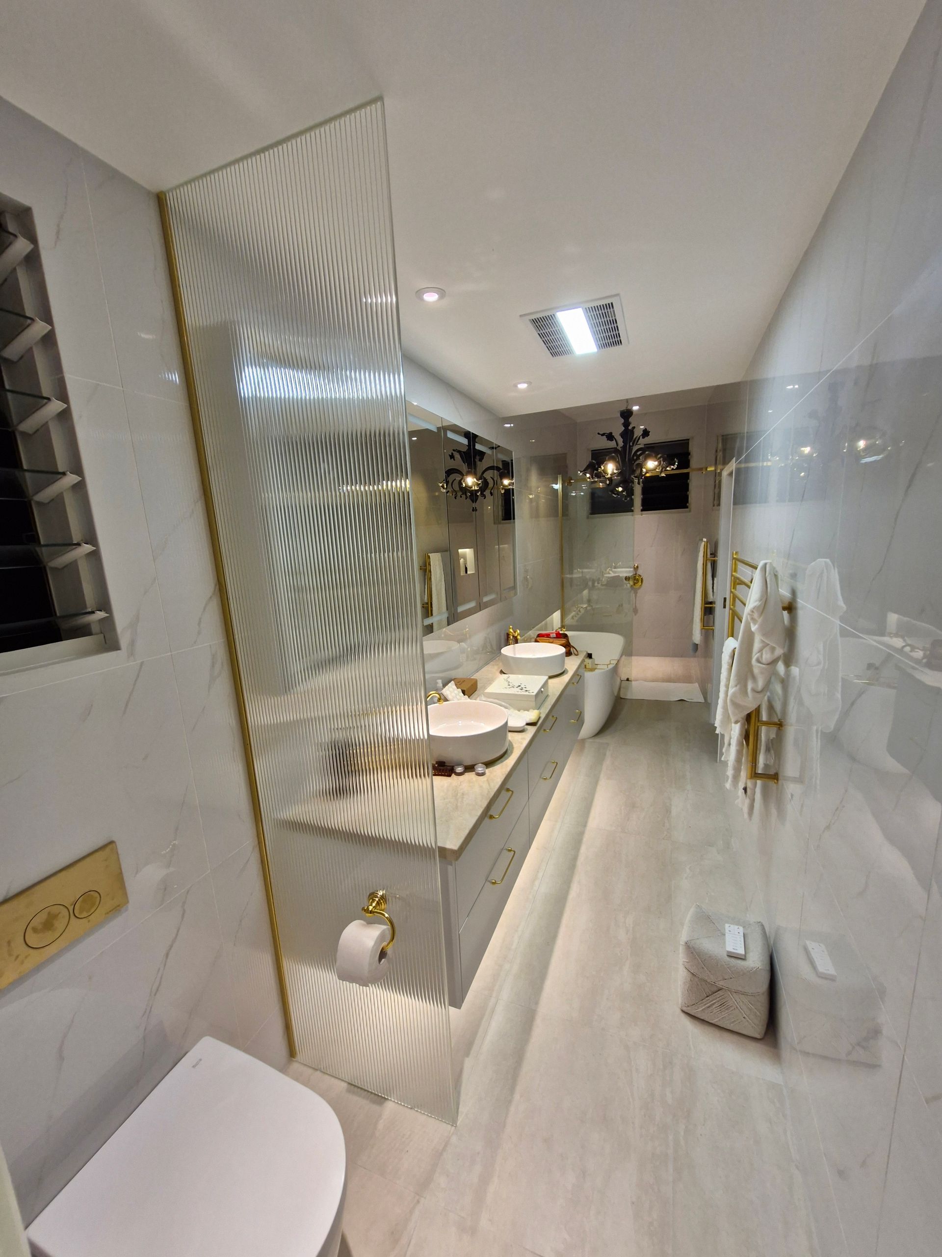 Luxurious bathroom with marble walls, double vanity, and ornate gold accents — K & J Glass in Urunga, NSW