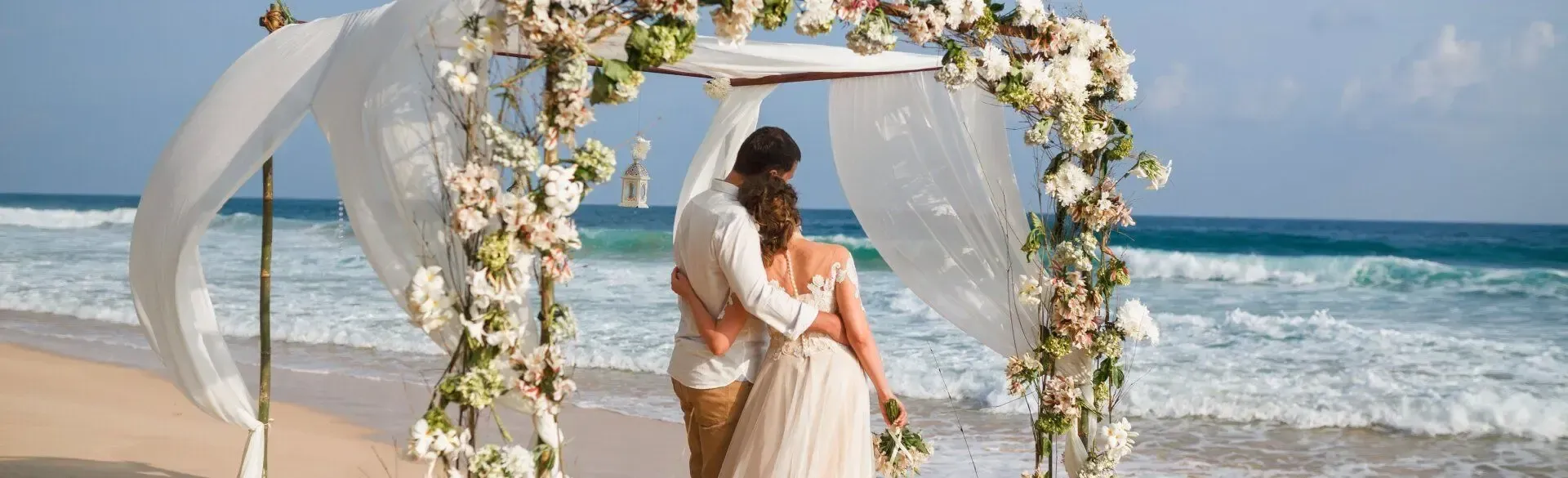 Bride and groom looking on the sea