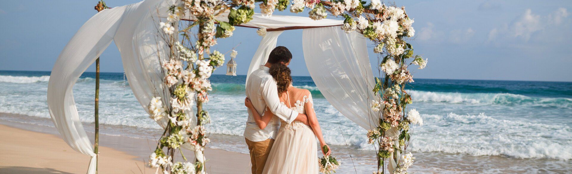 Bride and groom looking on the sea