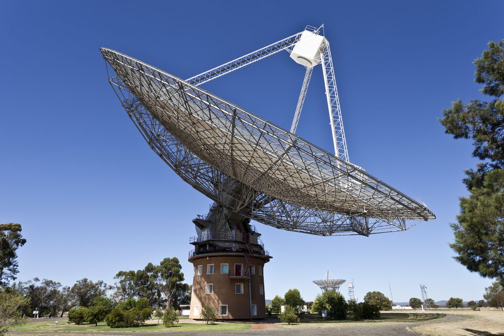 A Large Satellite Dish is Sitting on Top of a Building — Steel Frame Company In Parkes, NSW