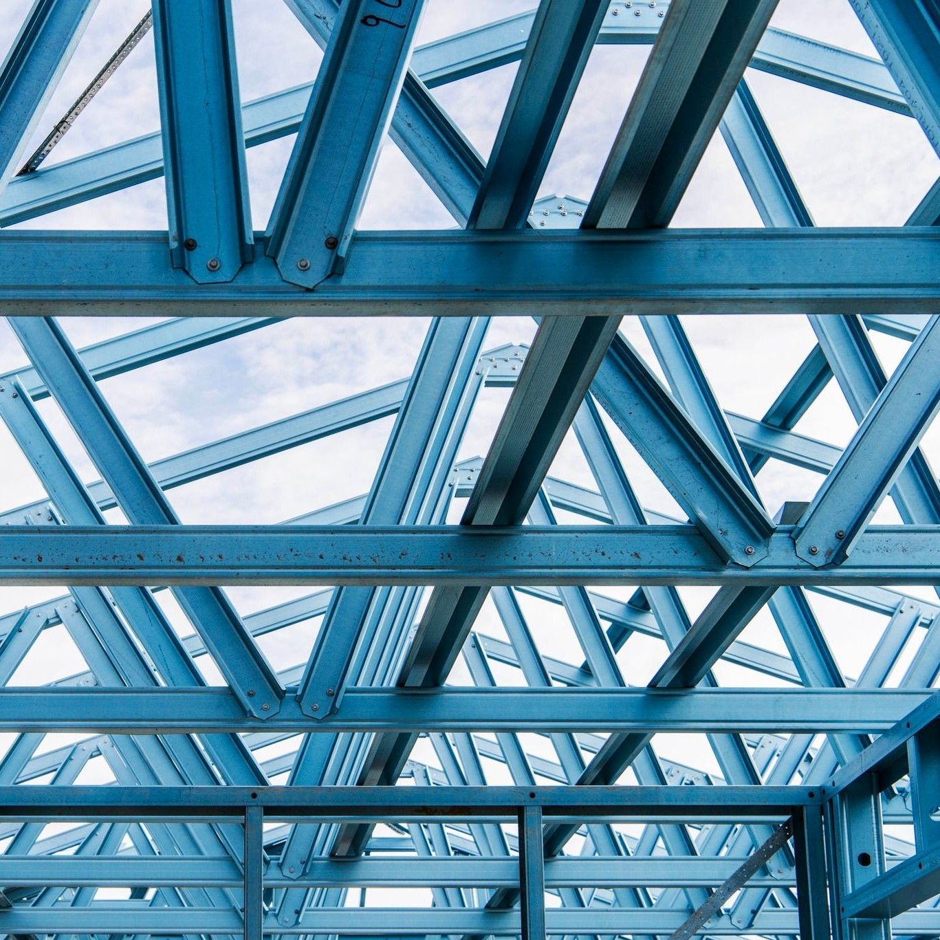 A Close Up of a Blue Metal Structure With a Cloudy Sky — Steel Frame Company In Mudgee, NSW