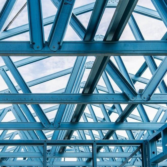 A Close Up of a Blue Metal Structure With a Blue Sky in the Background — Steel Frame Company In Maitland, NSW
