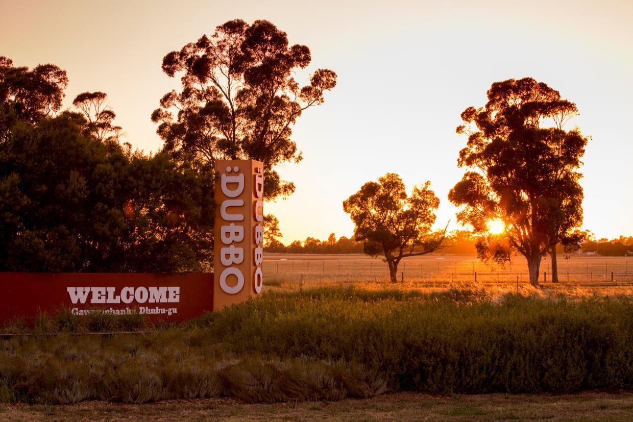 A Welcome Sign in a Field With Trees in the Background — Steel Frame Company In Dubbo, NSW