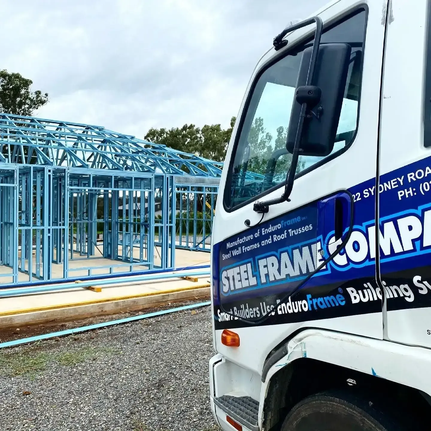 A Steel Frame Company Truck is Parked in Front of a Building — Steel Frame Company In Forbes, NSW