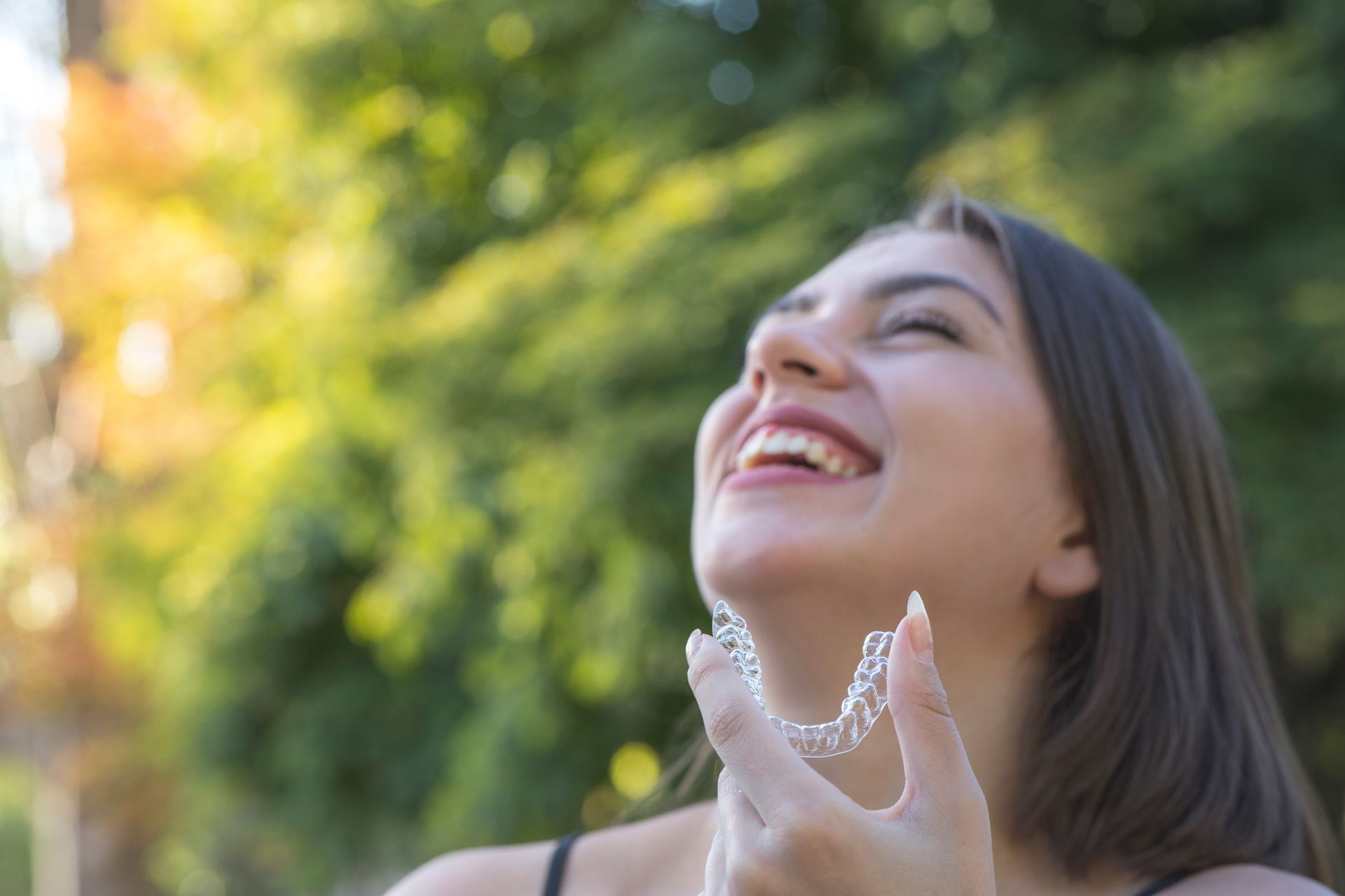 Woman with a stunning new smile | Visit a cosmetic dentist in Davenport, FL.
