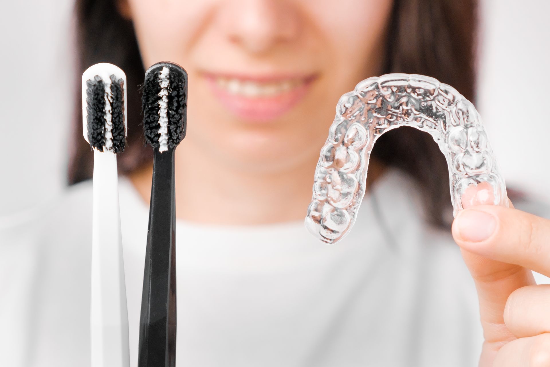 Woman protecting her teeth with a nightguard | Receive nightguards in Four Corners, FL.