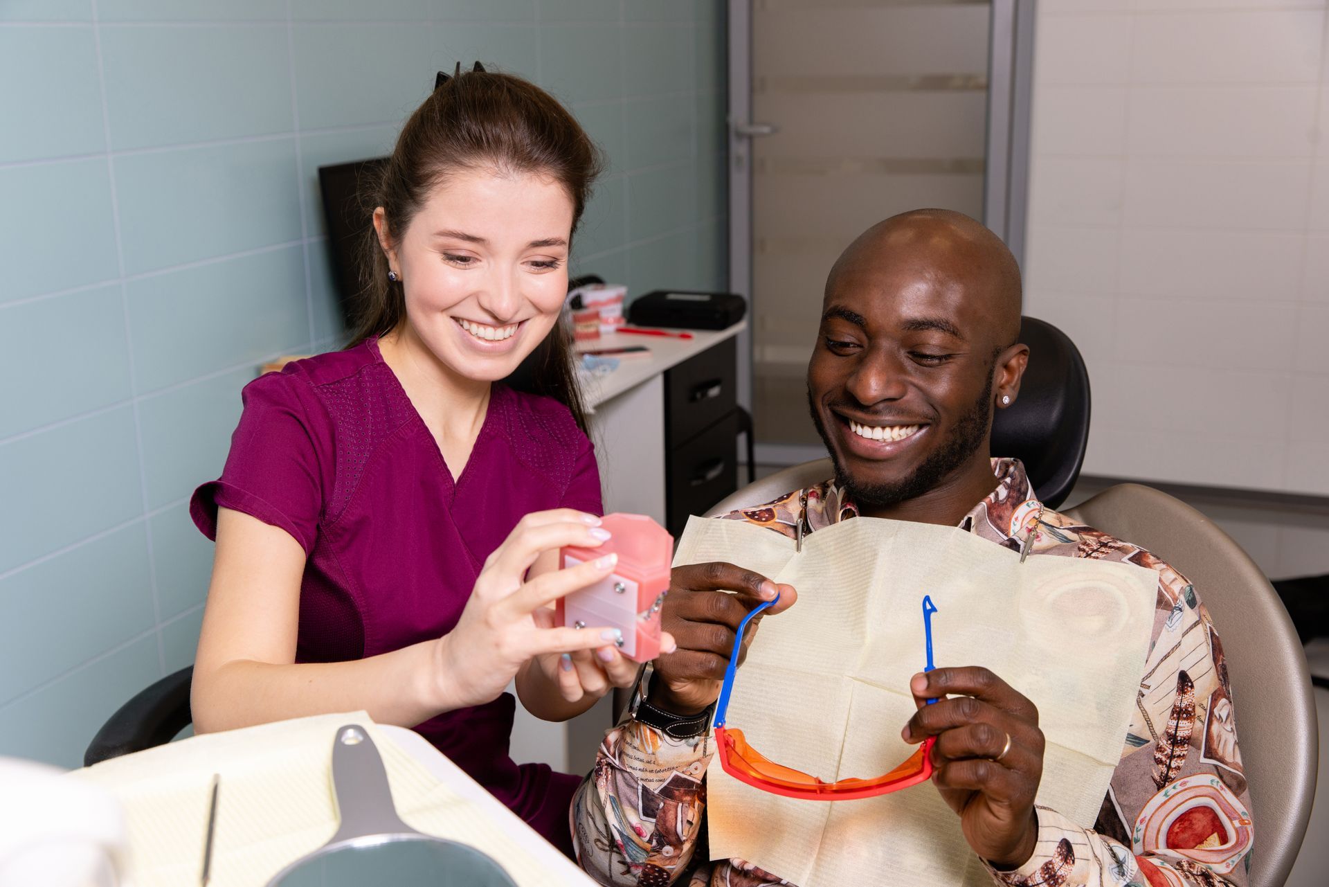Dentist performing an oral exam | Schedule an oral cancer exam in Davenport, FL.