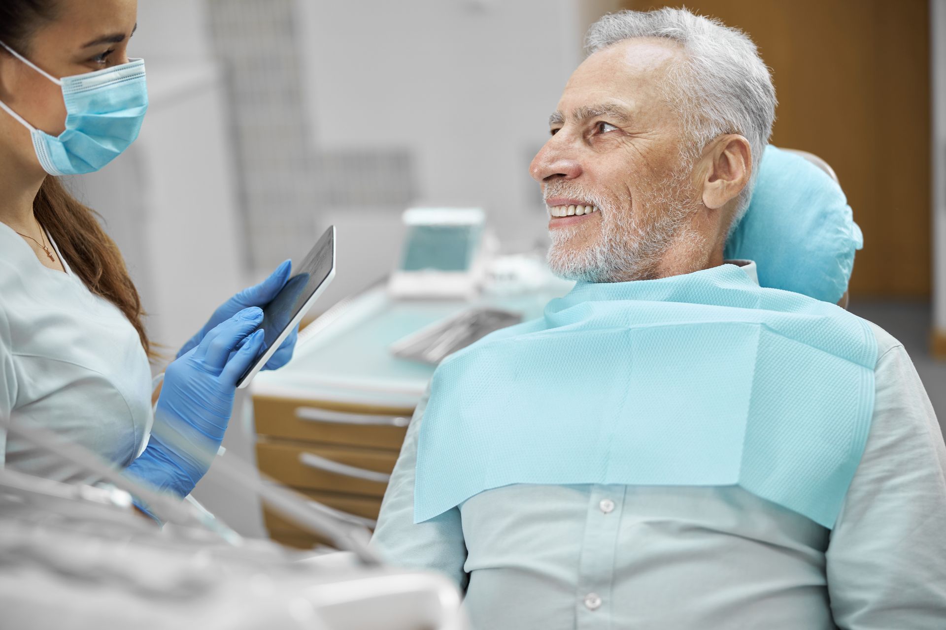 Elderly man with a new set of dentures | Get dentures in Davenport, FL.