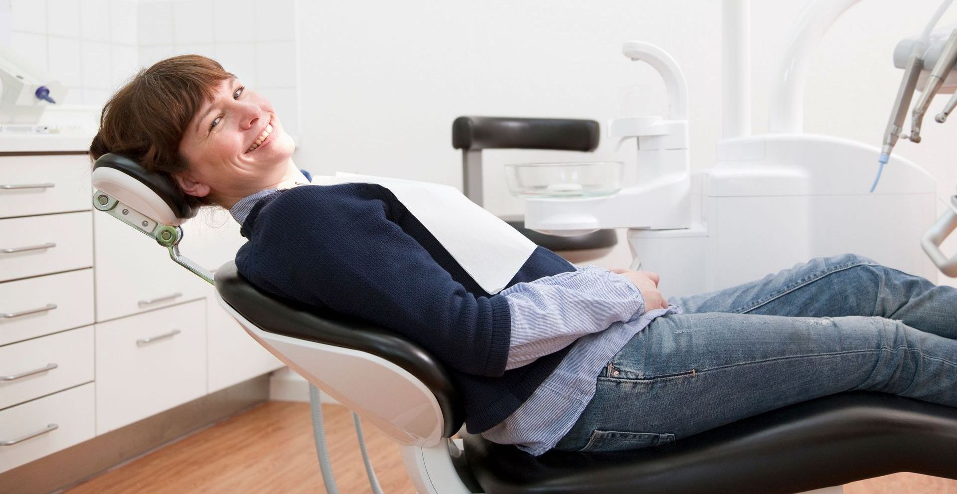 Woman smiling during a dental check-up | Choose a trusted Davenport dentist.