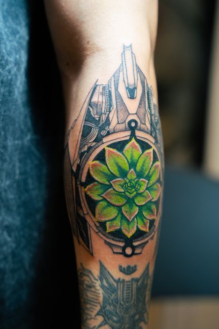 Detailed geometric tattoo with precise linework and symmetrical patterns on an arm