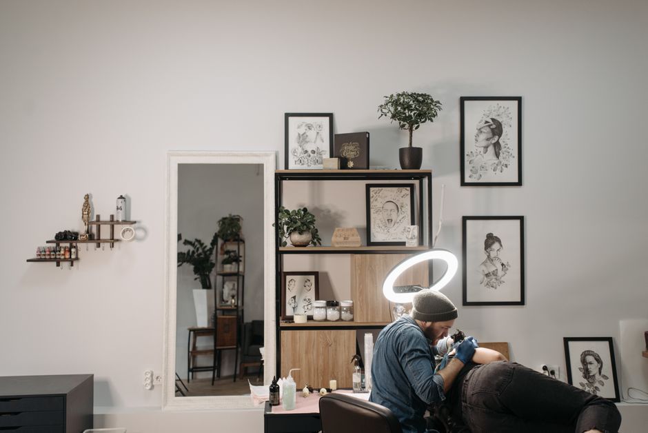 Tattooist discussing pricing with a client during a consultation in a London studio