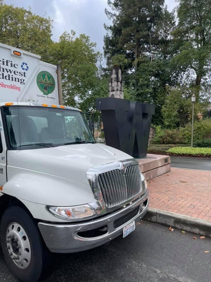 A white truck is parked on the side of the road.