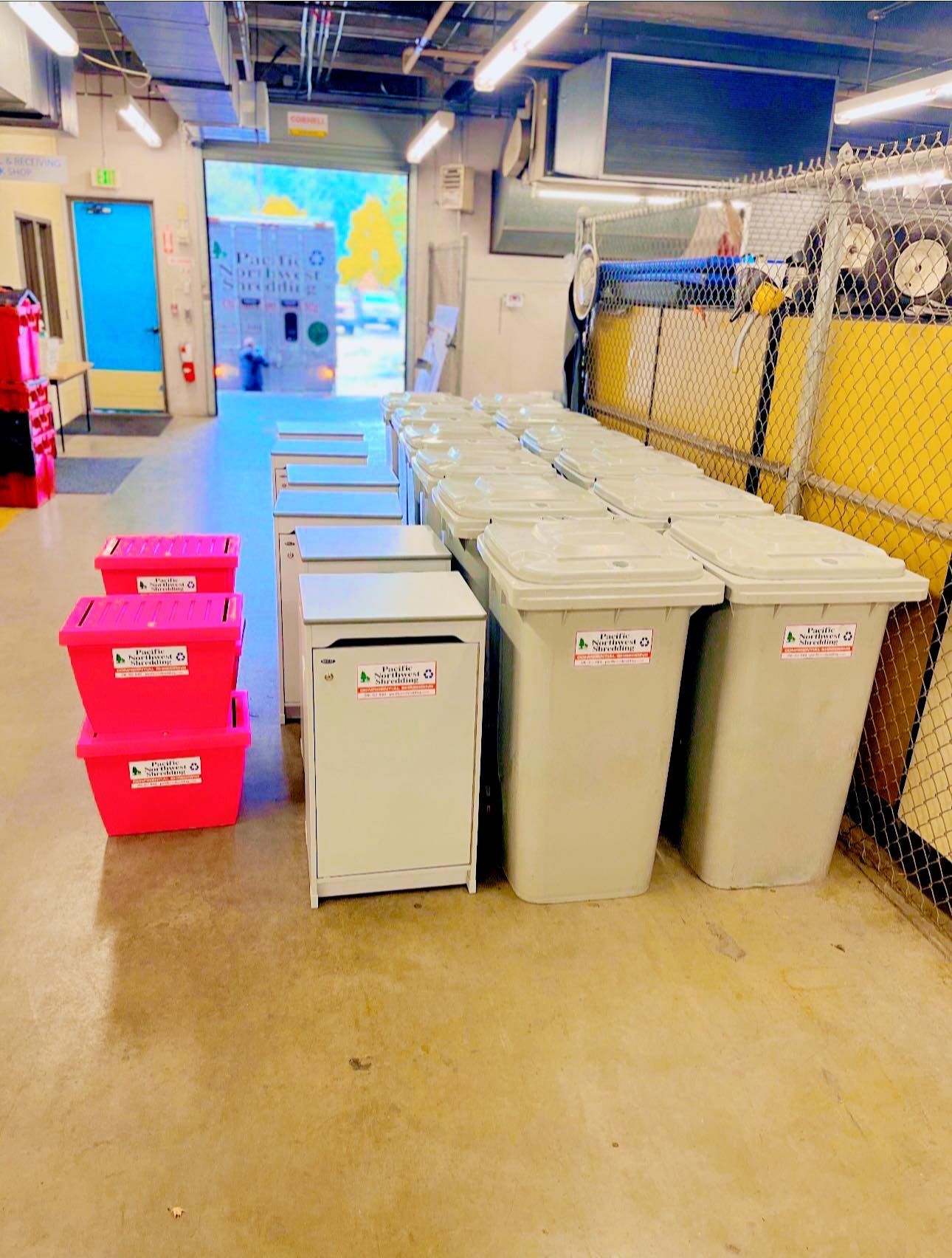 A room with a lot of trash cans and boxes