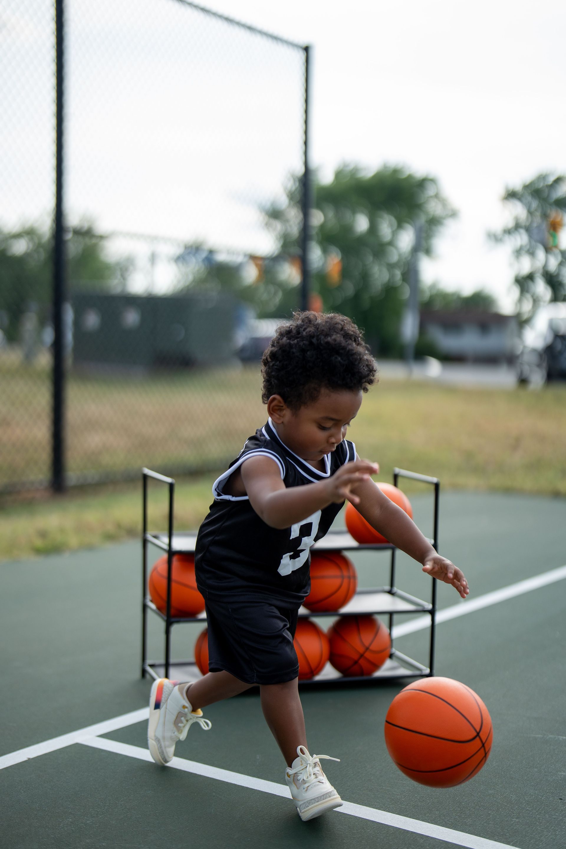 toddle playing with basketball