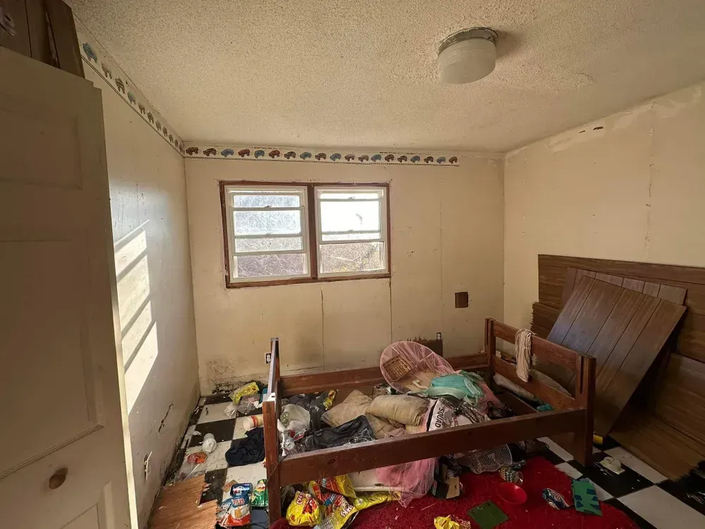 A bedroom with a bunk bed and a checkered floor.
