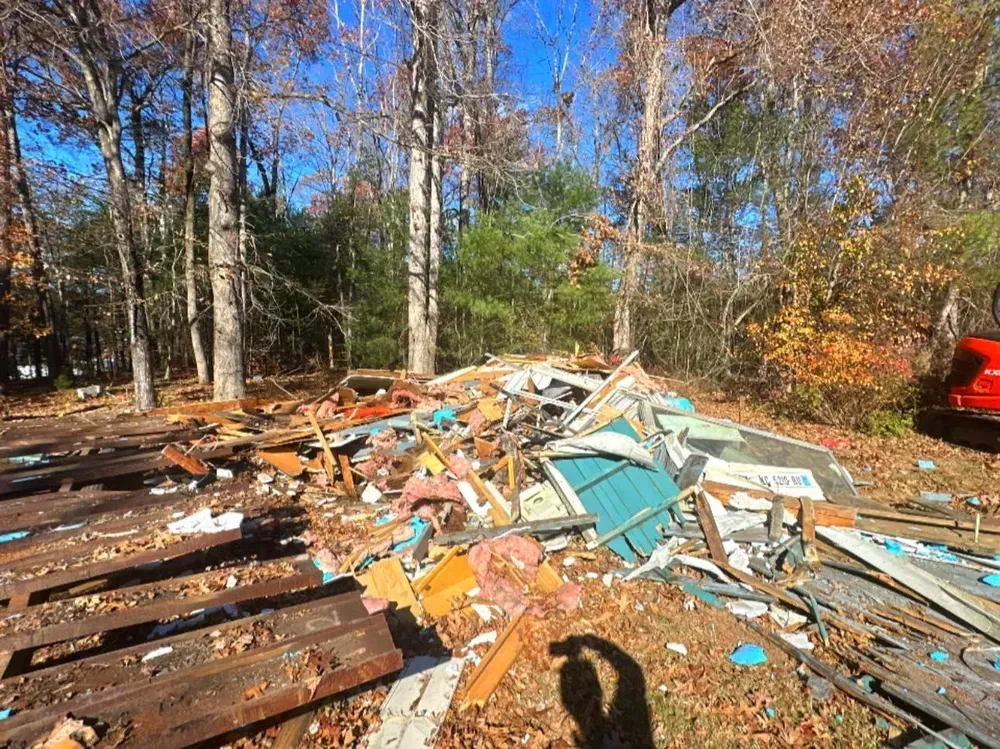 A pile of wood and metal is sitting in the middle of a forest.