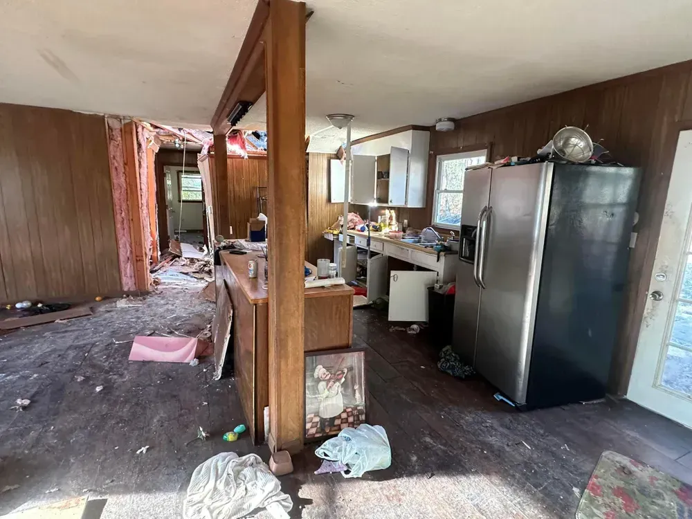 There is a refrigerator in the middle of the room.