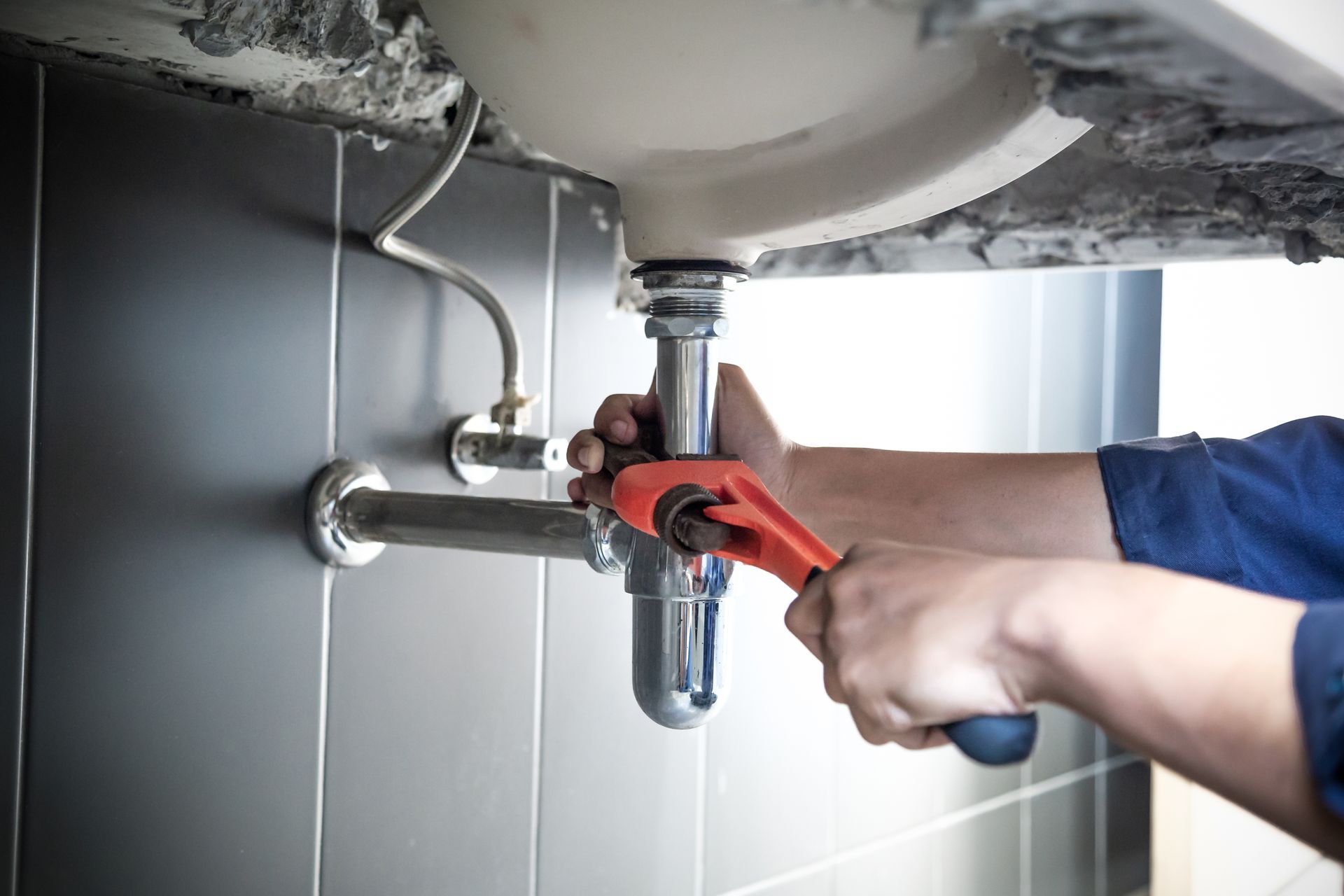 Installing new kitchen faucet over black sink during plumbing fixture upgrade in NJ home