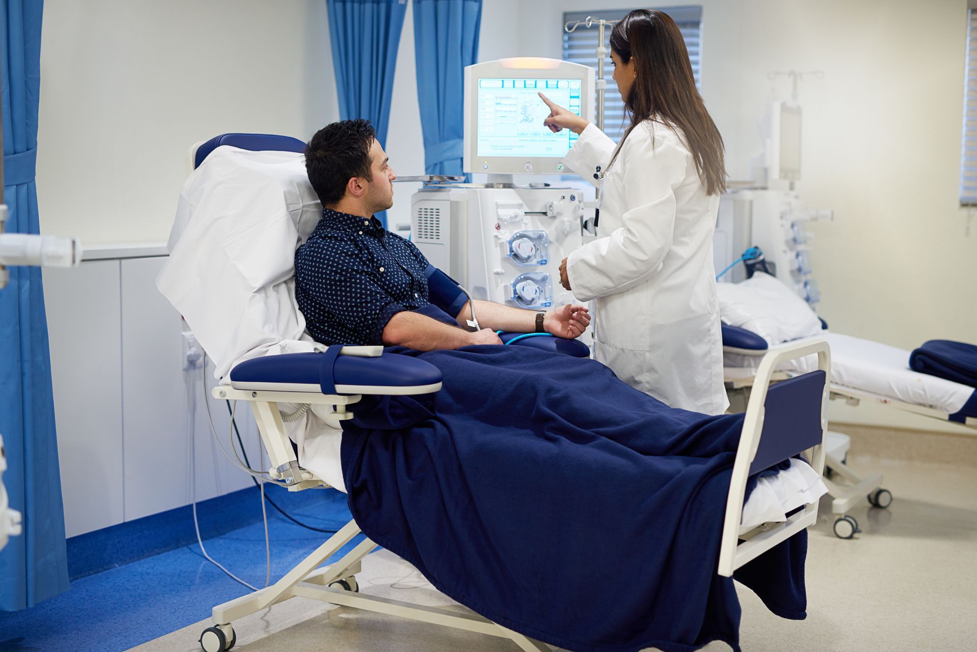 Man and doctor with dialysis machine for kidney assessment and hemodialysis care.